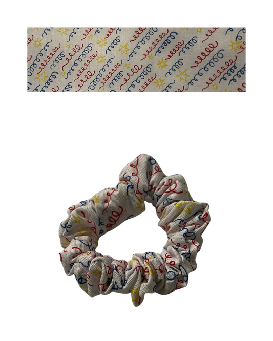 Primary colors party streamers on white fabric