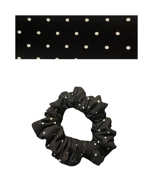 Black scrunchie with white polka dots on a white background