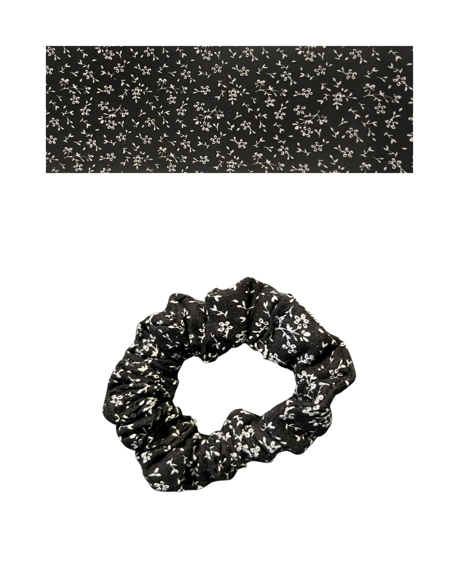 Black scrunchie on a white floral patterned.