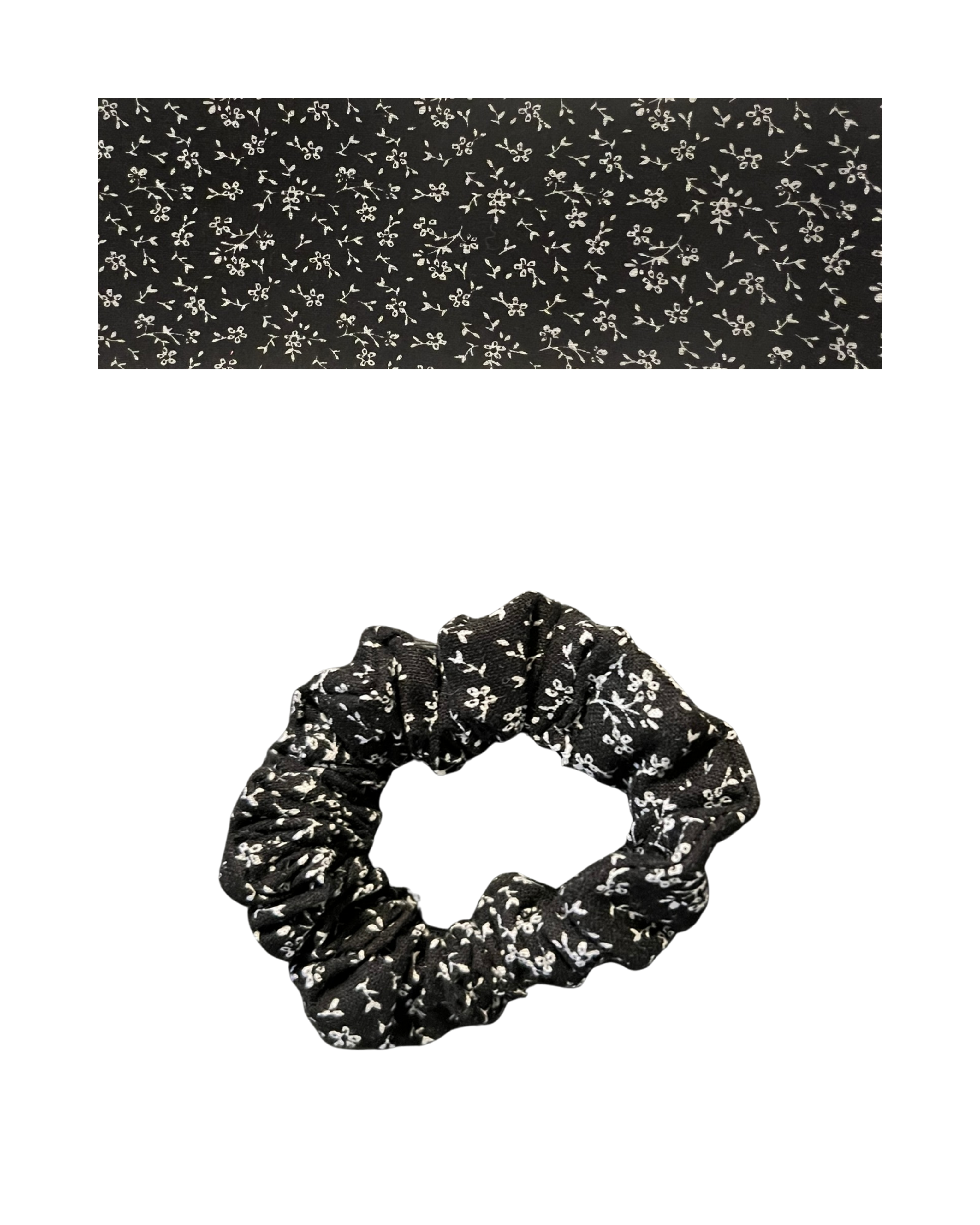 Black scrunchie on a white floral patterned.